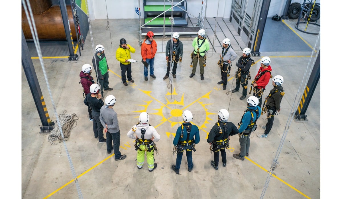 safety briefing for workers in hard hats stood in circle