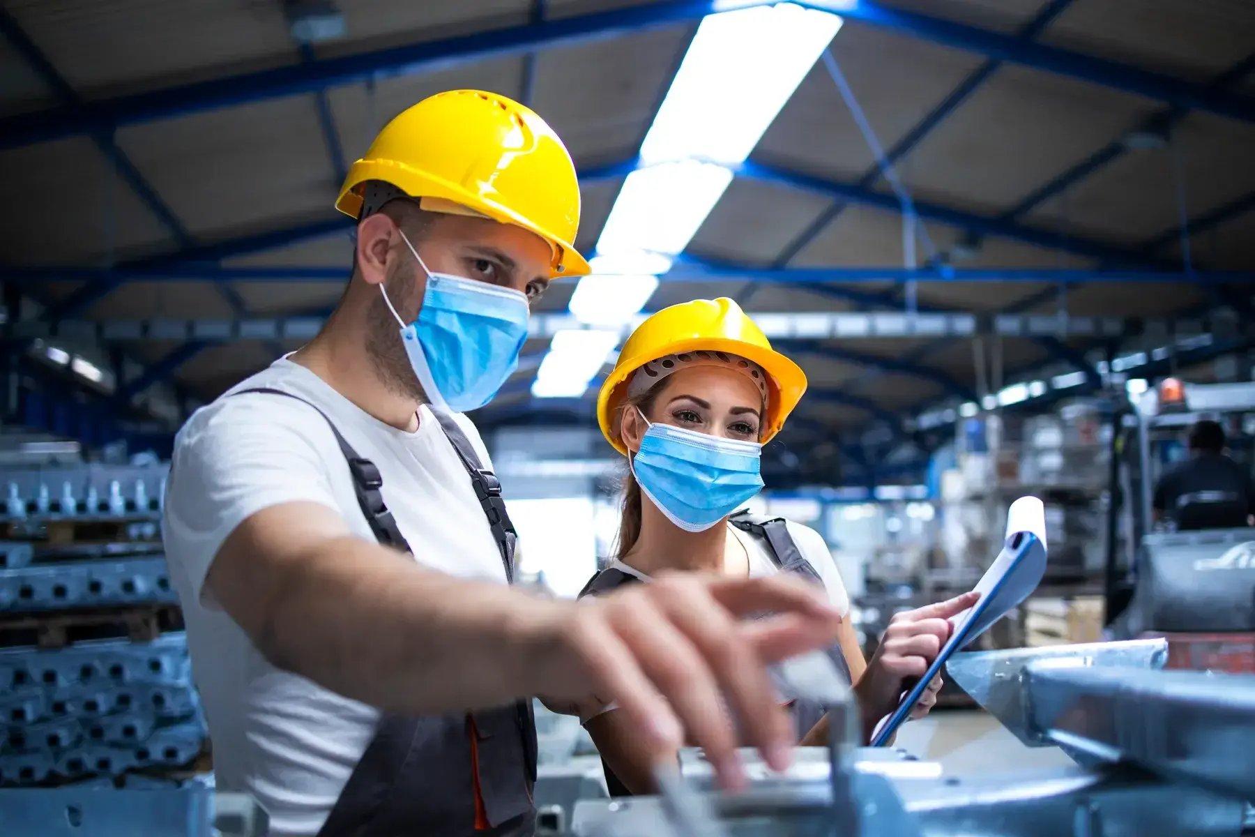 industrial-workers-with-face-masks-protected-against-corona-virus-discussing-about-metal-parts-factory-small